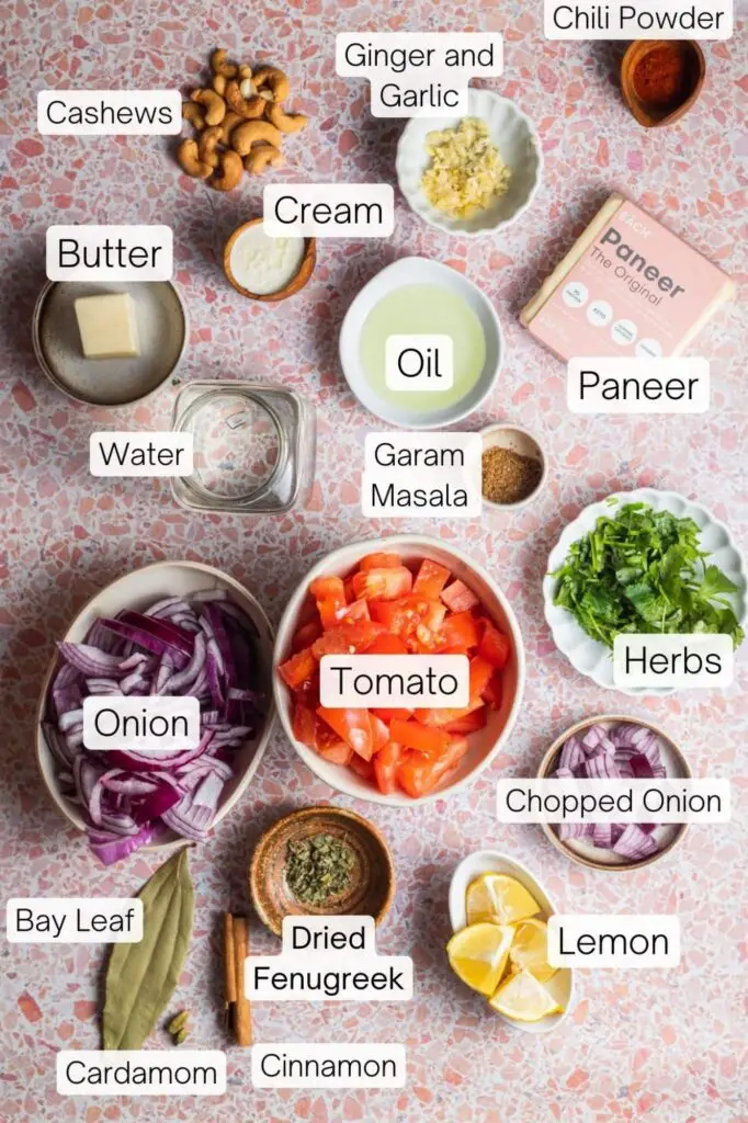 Paneer butter masala ingredients laid out on marble counter